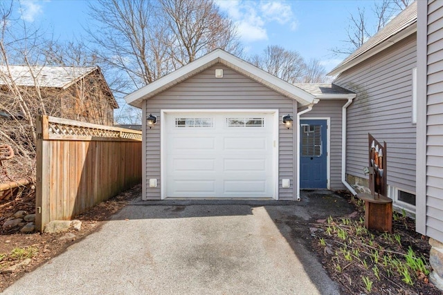 garage with fence and driveway