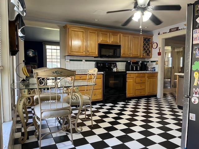 kitchen featuring tasteful backsplash, light countertops, ceiling fan, black appliances, and light floors