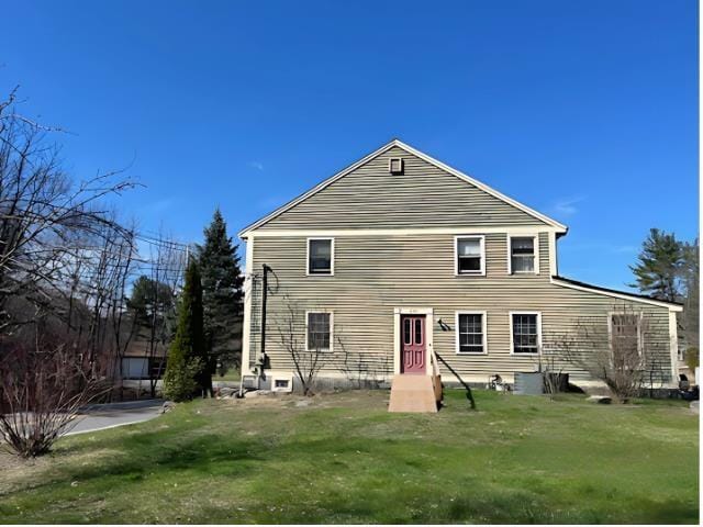 rear view of property with a yard