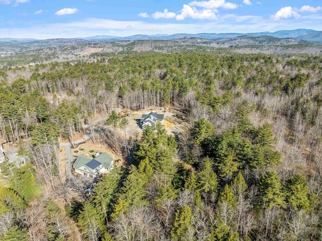aerial view with a wooded view and a mountain view