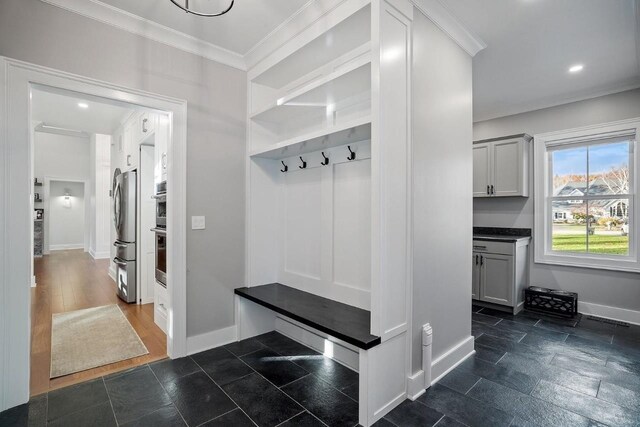 mudroom with ornamental molding, baseboards, and recessed lighting