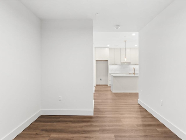 125 Cambrian Way Unit 605, Burlington, VT 05401 - unfurnished living room featuring baseboards, light wood-style floors, recessed lighting, and a sink