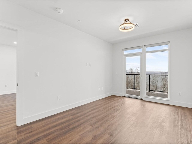 125 Cambrian Way Unit 605, Burlington, VT 05401 - unfurnished room with wood finished floors, baseboards, and a smoke detector