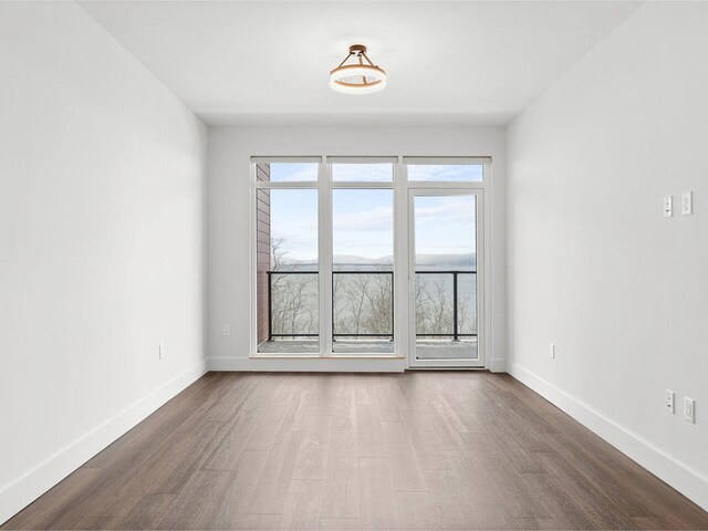 125 Cambrian Way Unit 605, Burlington, VT 05401 - empty room with wood finished floors and baseboards