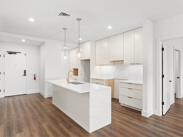 125 Cambrian Way Unit 605, Burlington, VT 05401 - kitchen with a sink, dark wood-style flooring, white cabinetry, a kitchen island with sink, and recessed lighting