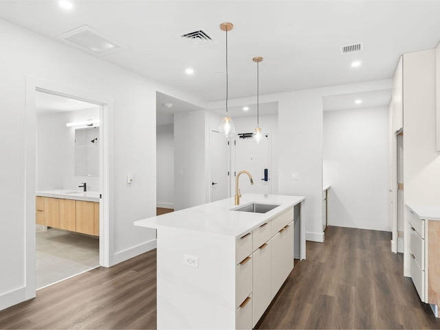 125 Cambrian Way Unit 605, Burlington, VT 05401 - kitchen with a sink, modern cabinets, dark wood-style flooring, light countertops, and recessed lighting