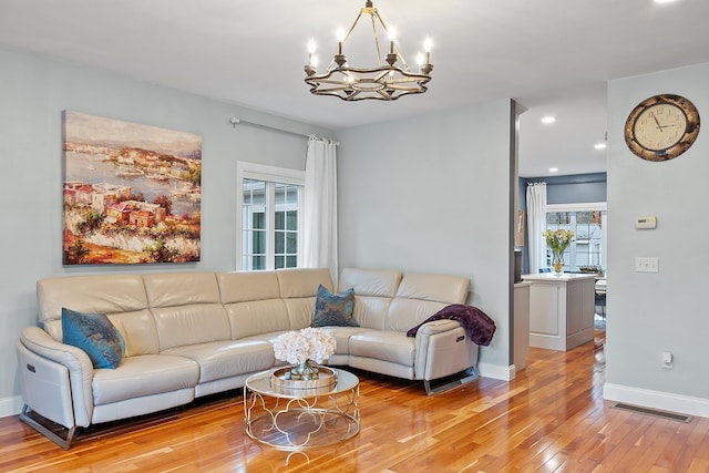 living room with light wood-type flooring, visible vents, recessed lighting, a chandelier, and baseboards