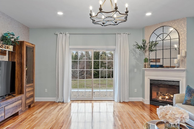 doorway with light wood-style flooring, a notable chandelier, baseboards, and recessed lighting