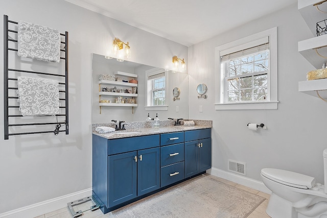 bathroom with visible vents, baseboards, a sink, and toilet