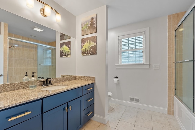 bathroom featuring vanity, visible vents, toilet, tile patterned floors, and baseboards