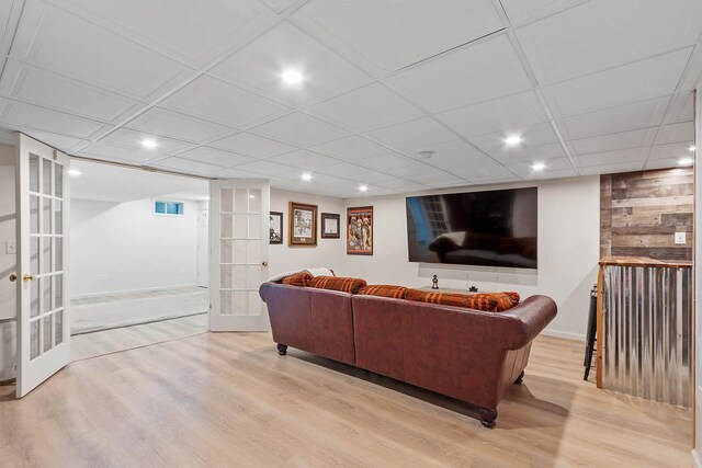living room with french doors, baseboards, recessed lighting, and light wood-style floors