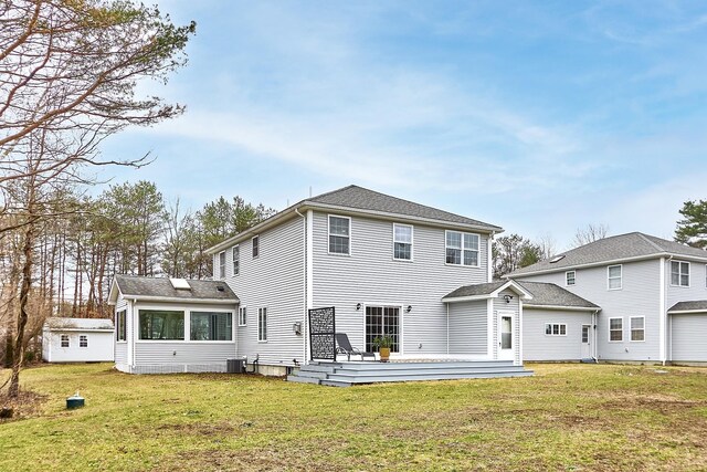 back of house featuring a yard, central AC unit, and a wooden deck