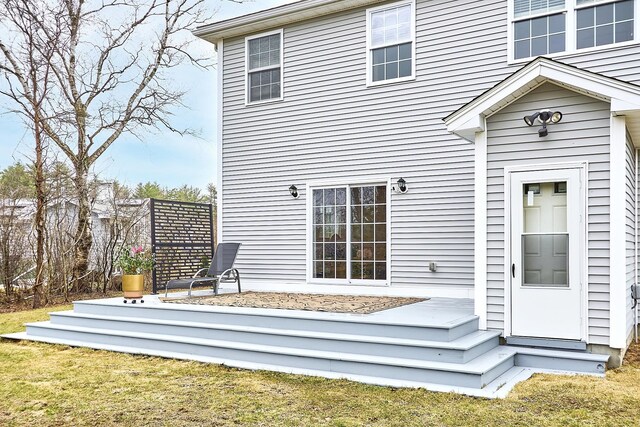 back of property featuring fence and a lawn