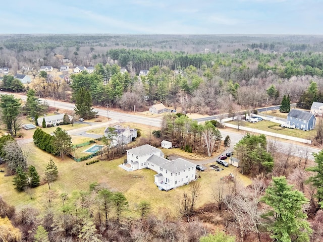 bird's eye view featuring a wooded view