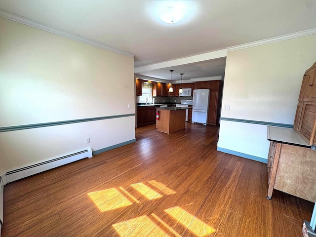 unfurnished living room featuring baseboard heating, crown molding, dark wood-style flooring, and baseboards