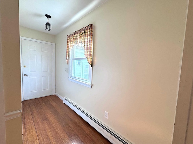 doorway to outside with dark wood-type flooring and baseboards