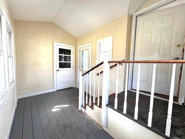 foyer featuring wood-type flooring, baseboards, and lofted ceiling