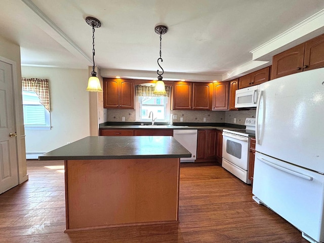 kitchen featuring dark wood finished floors, white appliances, a center island, dark countertops, and backsplash