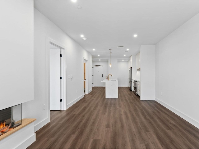 125 Cambrian Way Unit 611, Burlington, VT 05401 - unfurnished living room with dark wood-style floors and recessed lighting
