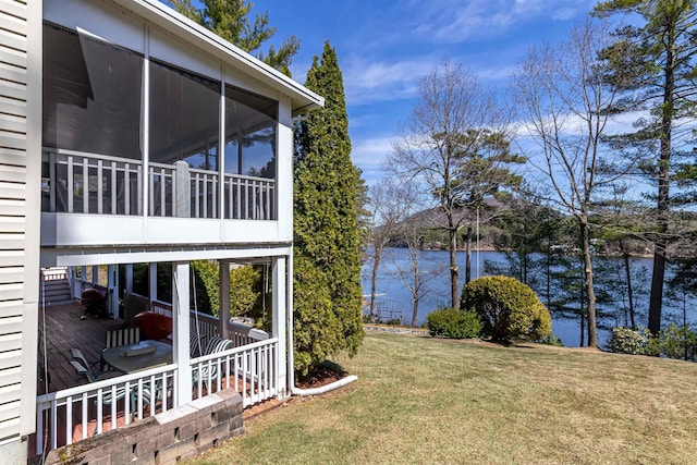 exterior space with a sunroom and a water view