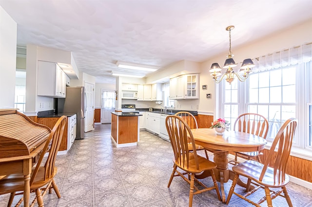 dining area featuring a chandelier and light floors