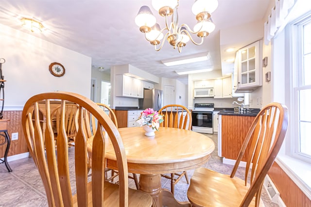 dining area featuring a chandelier and plenty of natural light