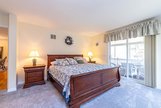 carpeted bedroom featuring visible vents, access to exterior, and baseboards