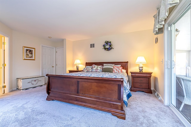 bedroom with light carpet, visible vents, and baseboards