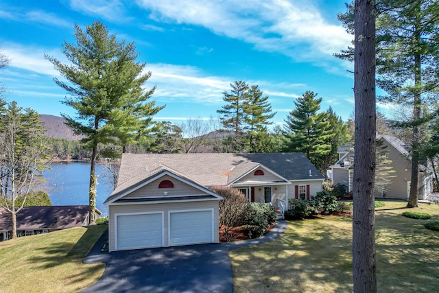 view of front of property featuring a water view, a front yard, driveway, and a garage