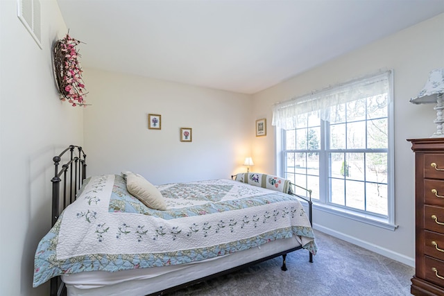 bedroom featuring carpet flooring, visible vents, and baseboards