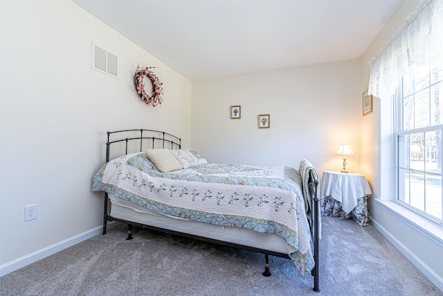 bedroom with visible vents, baseboards, and carpet floors