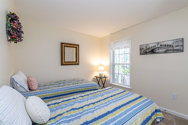 bedroom featuring baseboards and carpet