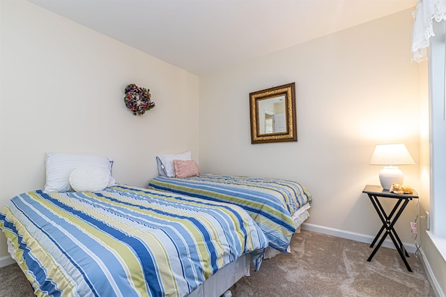 bedroom with baseboards and carpet flooring