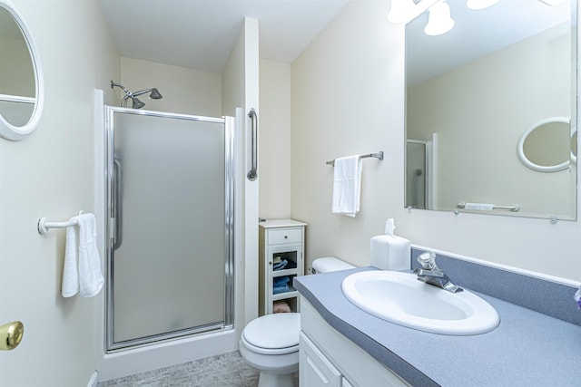 full bath featuring a shower stall, vanity, and toilet