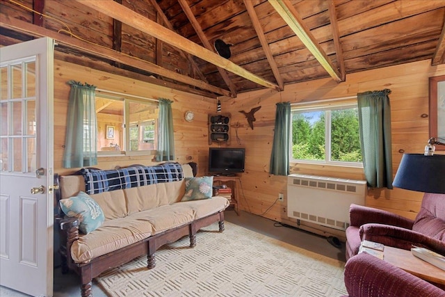 living area with wood walls, vaulted ceiling with beams, wooden ceiling, and radiator