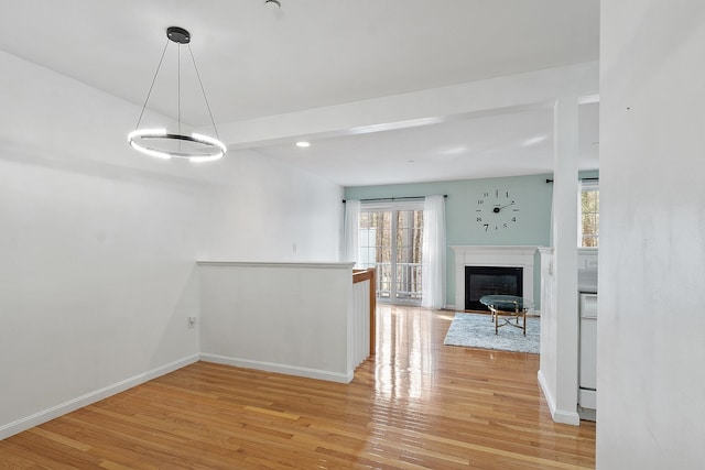 68 Barrington Ave, Nashua, NH 03062 - interior space featuring light wood-style flooring, recessed lighting, a glass covered fireplace, and baseboards