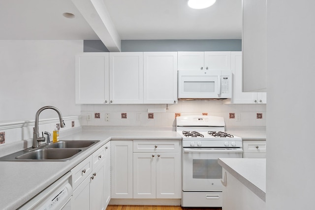 68 Barrington Ave, Nashua, NH 03062 - kitchen with white appliances, light countertops, white cabinets, decorative backsplash, and a sink