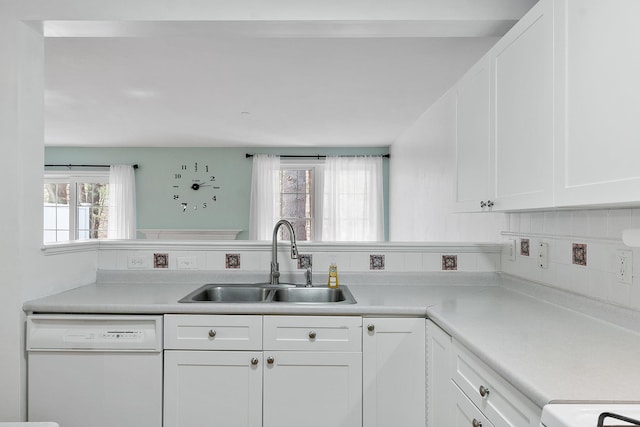 68 Barrington Ave, Nashua, NH 03062 - kitchen with light countertops, white dishwasher, white cabinetry, and a sink