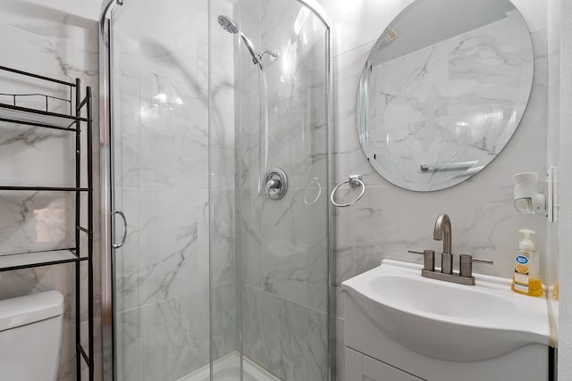 68 Barrington Ave, Nashua, NH 03062 - full bathroom featuring toilet, a marble finish shower, vanity, and tile walls