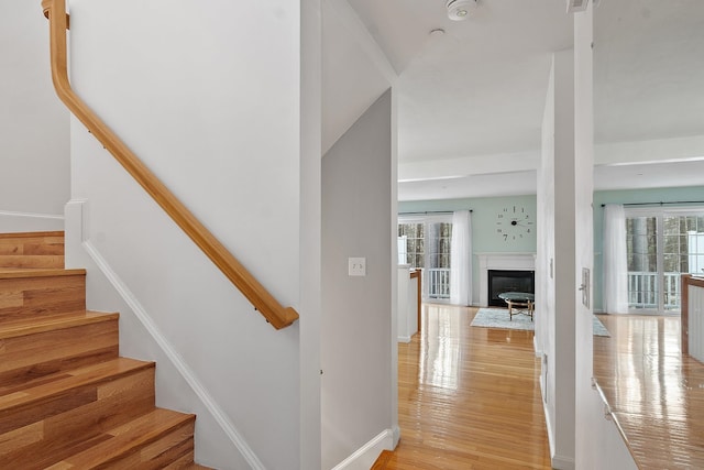 68 Barrington Ave, Nashua, NH 03062 - stairway featuring a fireplace with flush hearth, wood finished floors, and baseboards