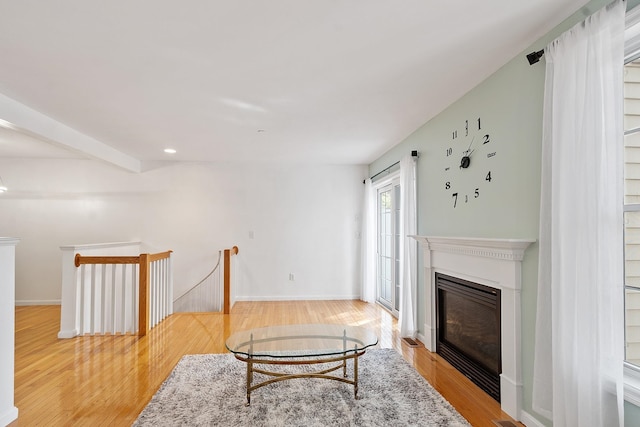 68 Barrington Ave, Nashua, NH 03062 - living area featuring light wood-style flooring, recessed lighting, a glass covered fireplace, and baseboards