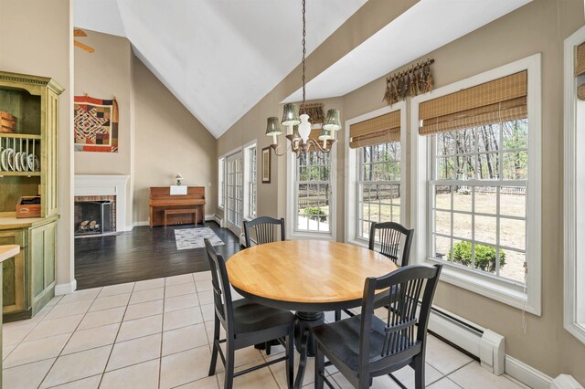 23 Bear Hill Rd, Windham, NH 03087 - dining space featuring plenty of natural light, a chandelier, a baseboard heating unit, light tile patterned floors, and high vaulted ceiling