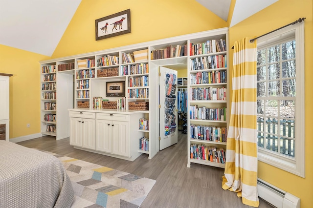 23 Bear Hill Rd, Windham, NH 03087 - bedroom featuring lofted ceiling, a baseboard heating unit, wood finished floors, and a walk in closet