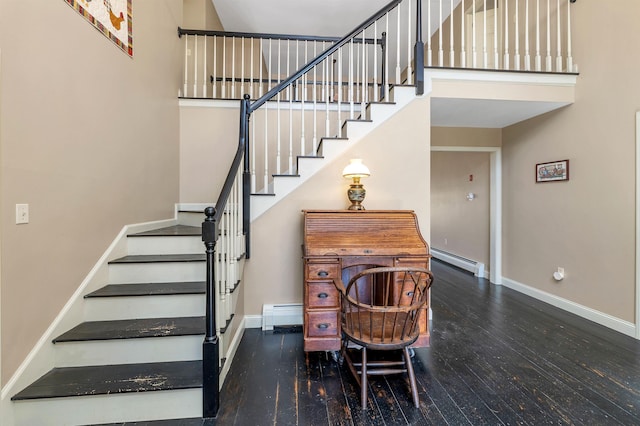 23 Bear Hill Rd, Windham, NH 03087 - stairway with baseboard heating, a baseboard radiator, hardwood / wood-style floors, and a high ceiling