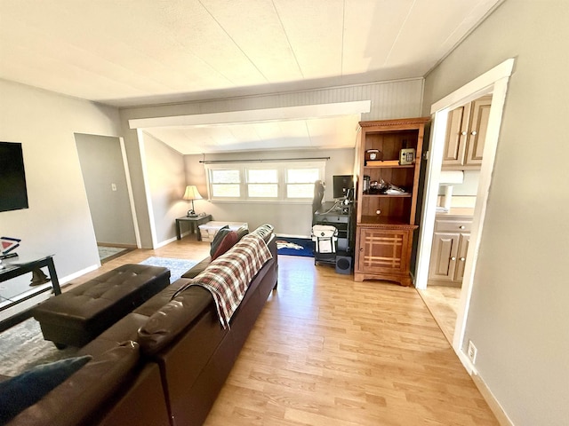 living room with light wood-style flooring and baseboards