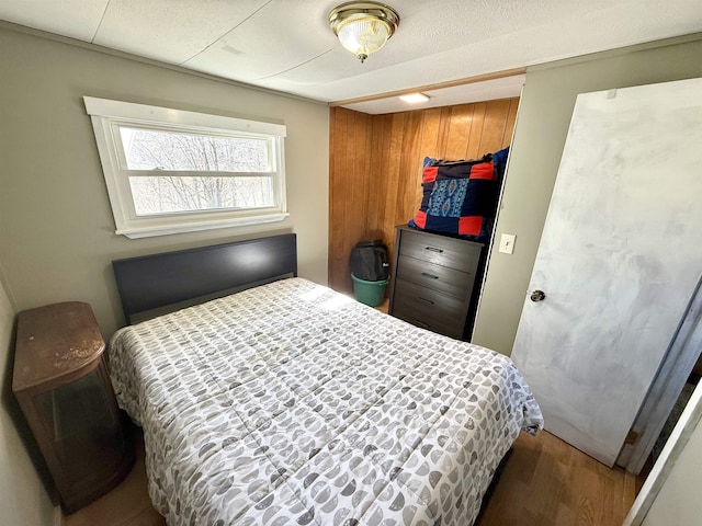 bedroom featuring wood finished floors and a closet
