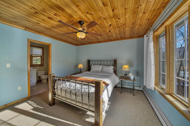 bedroom with a baseboard radiator, multiple windows, and carpet