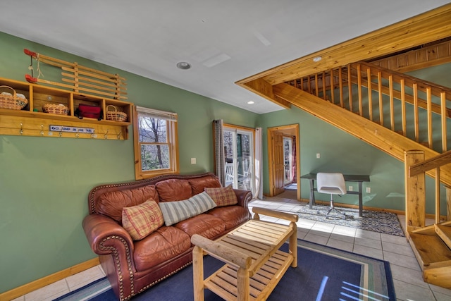 living area with baseboards, recessed lighting, tile patterned flooring, and stairs