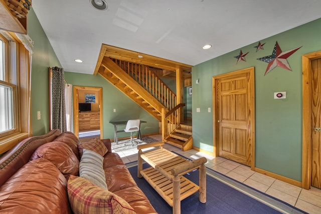 living area featuring tile patterned floors, recessed lighting, baseboards, and stairs