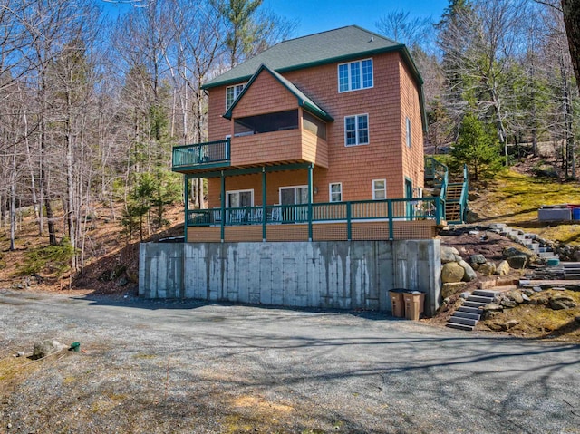 back of property featuring a shingled roof